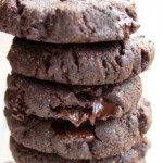 A stack of fudgy chocolate cookies with chocolate chips.