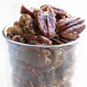 A glass jar with crunchy candied pecans.