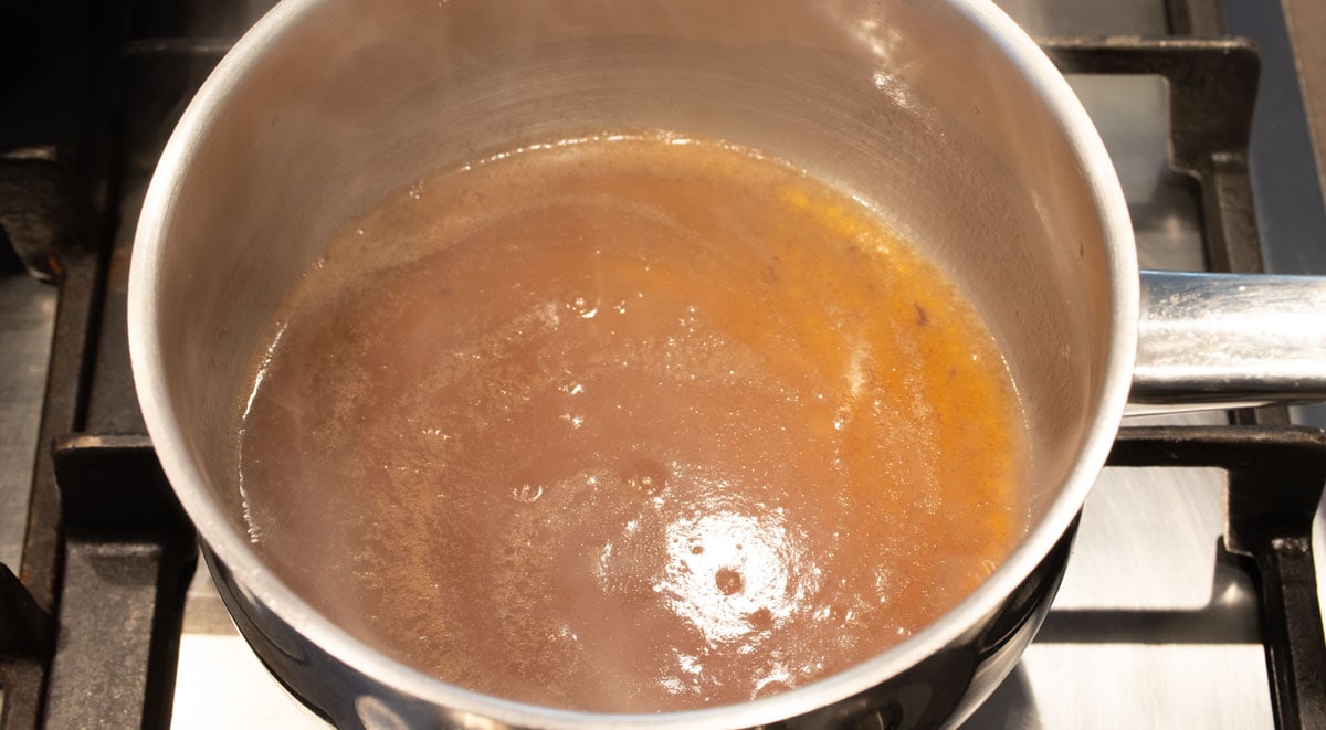 Caramel cooking in a pot.
