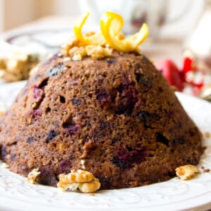 A christmas pudding topped with orange peel.