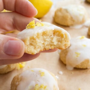 Hand holding an iced lemon cookie.