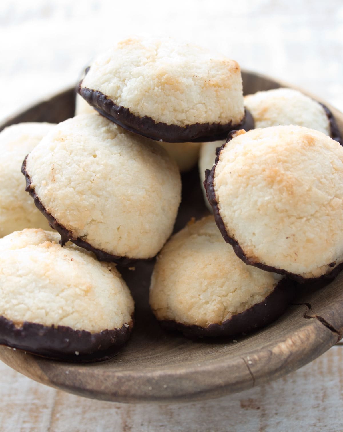 A wooden bowl with macaroons.