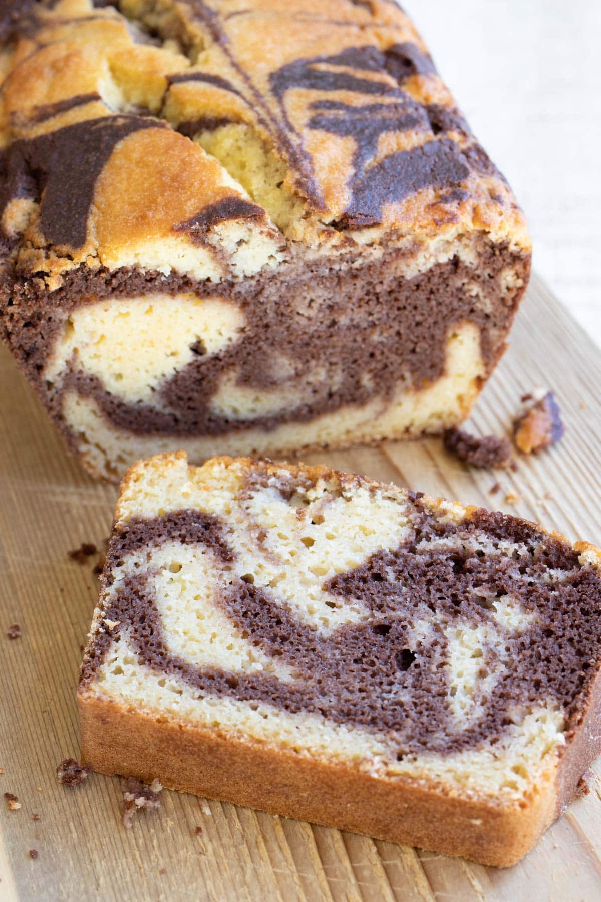 A slice of marble cake on a chopping board.