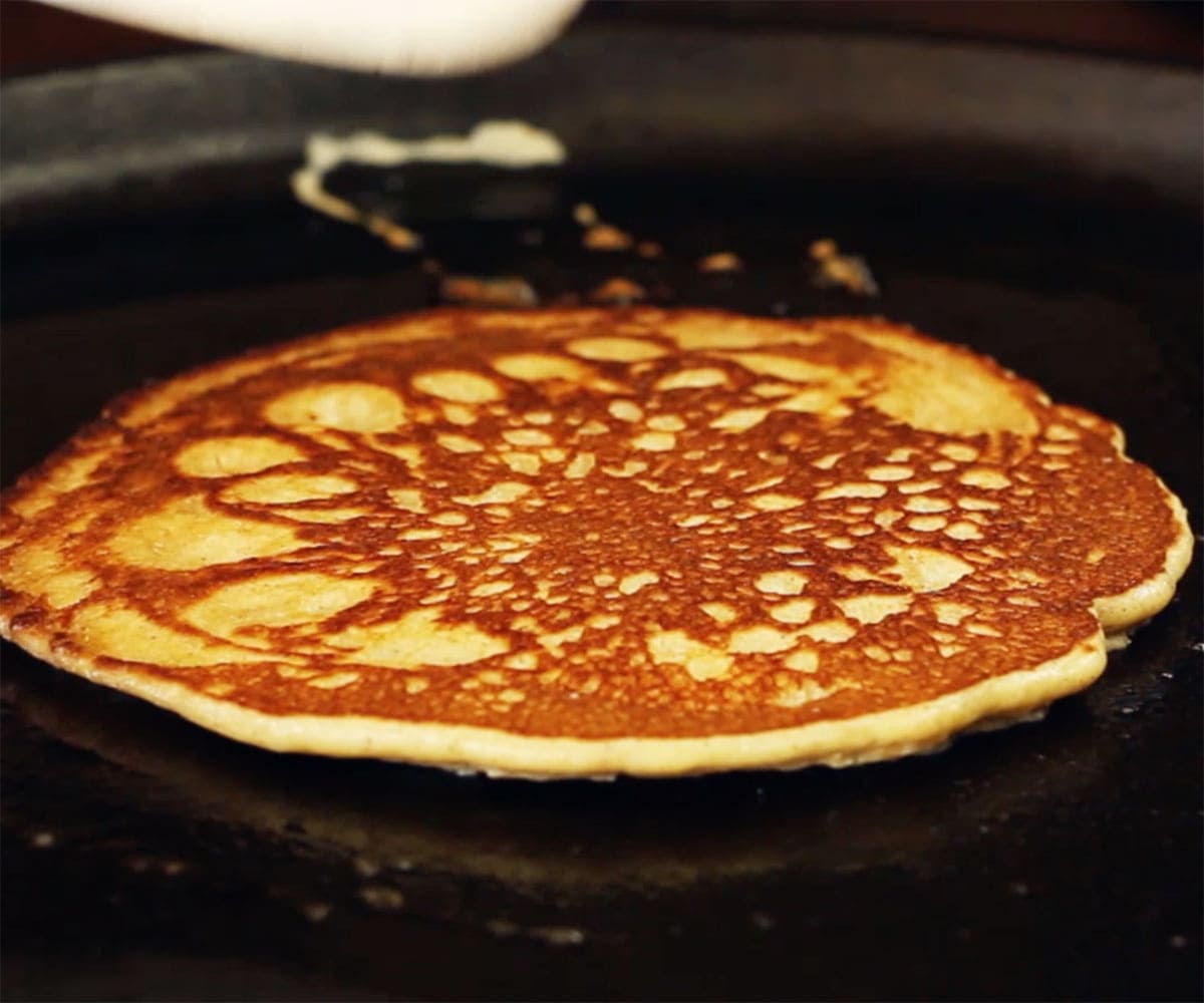 Frying a pancake in a pan.