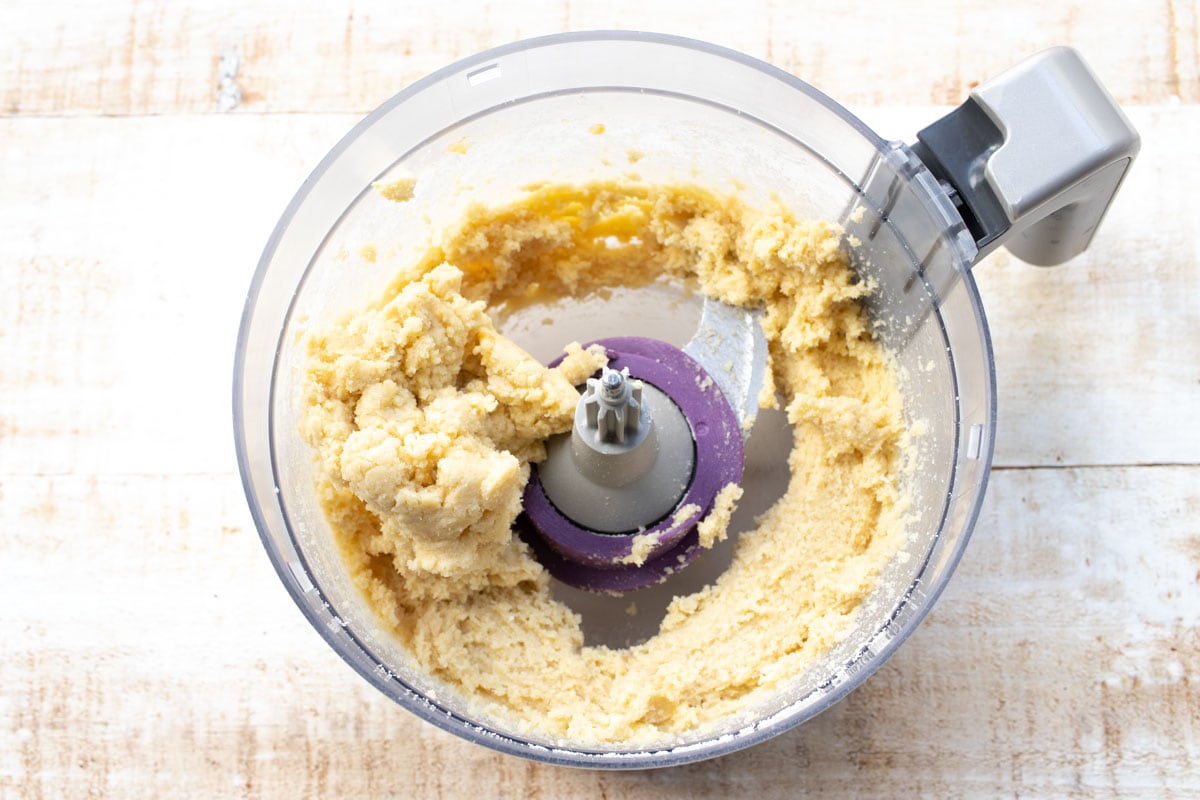 Cookie dough in a food processor bowl.