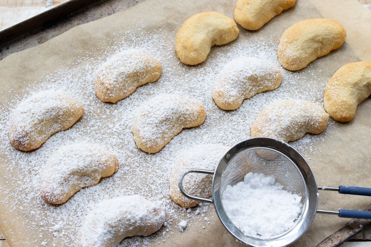 Dusting cookies with powdered sweetener.