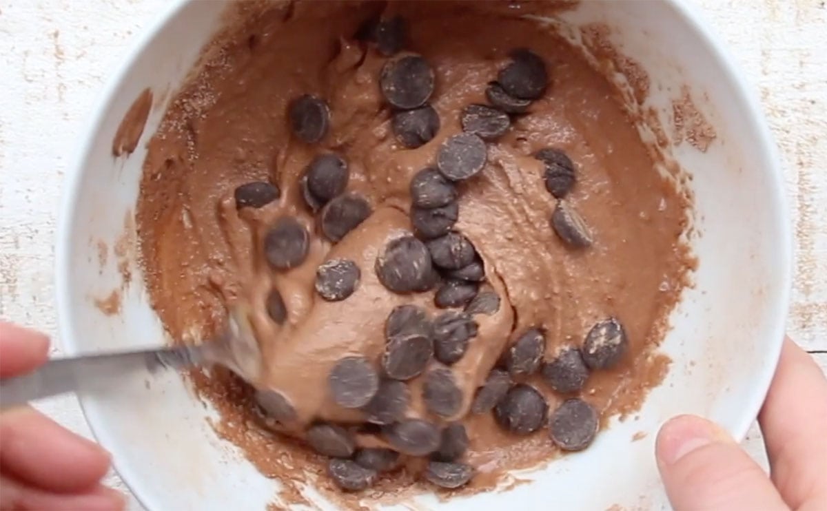 Stirring chocolate chips into the batter.