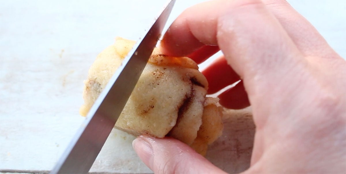 Knife cutting a roll in half.