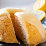 Closeup of a lemon cake slice with a creamy glaze.