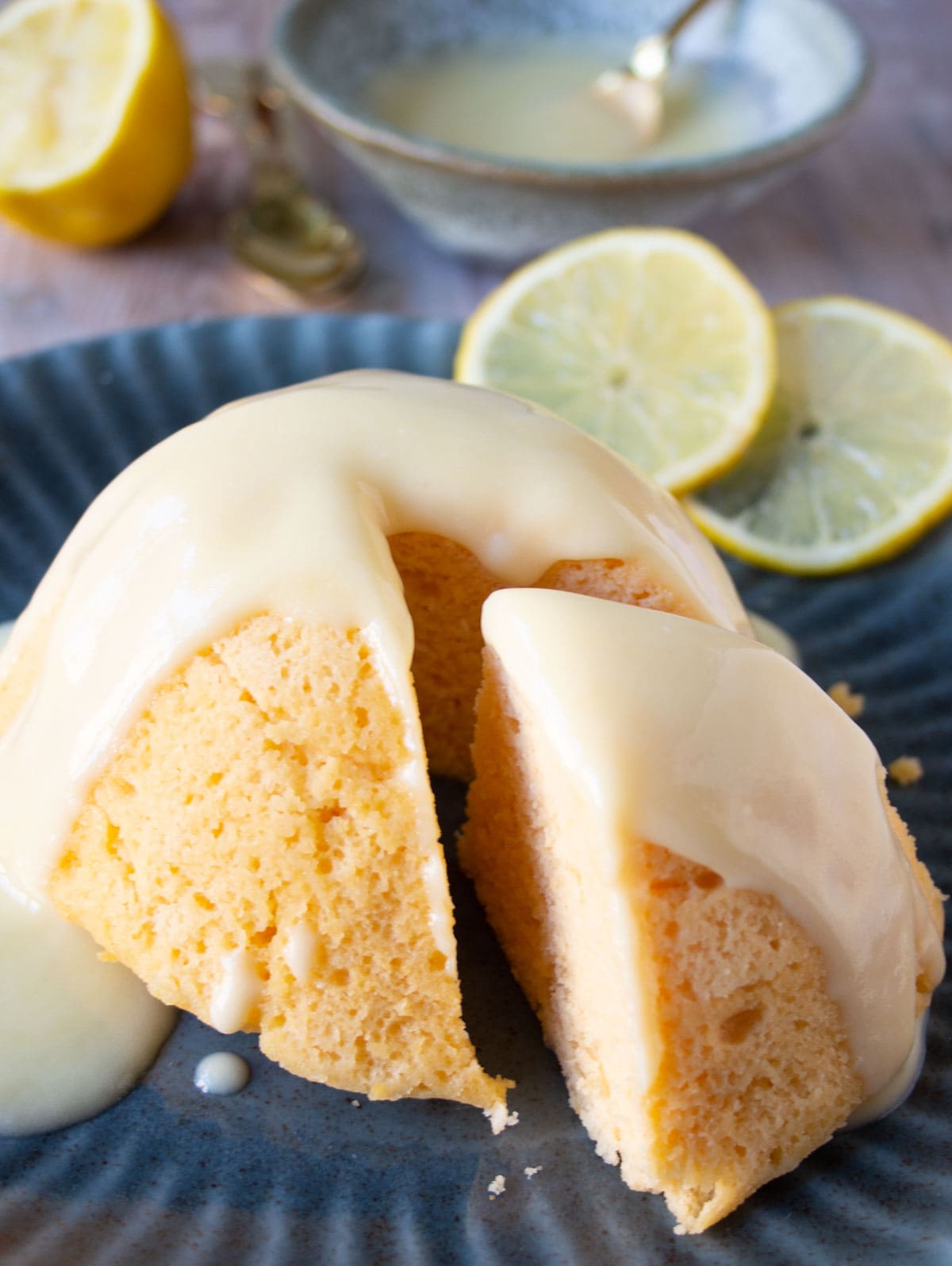 A lemon cake with lemon glaze on a plate.