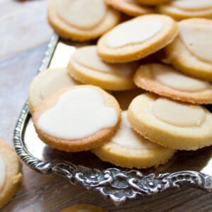A tray with round shortbread cookies topped with a glaze.