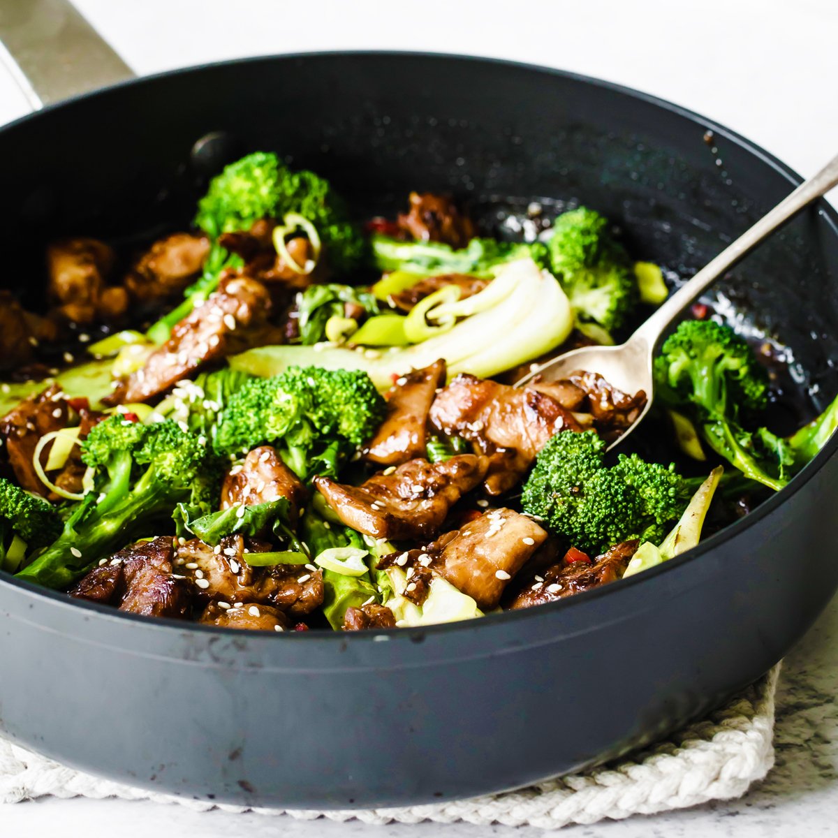 Teriyaki chicken with broccoli in a pan.