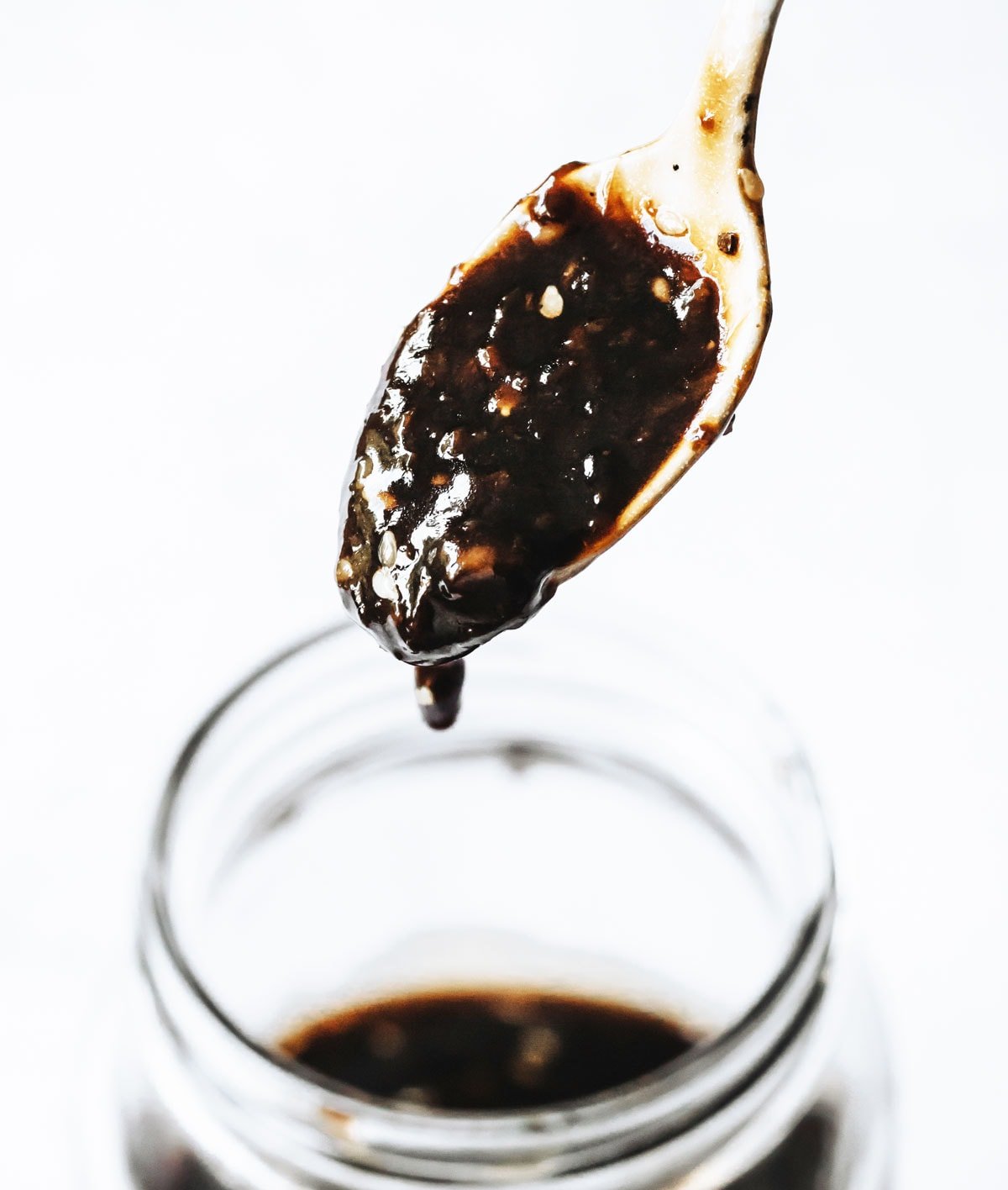 Teriyaki sauce dripping from a spoon.