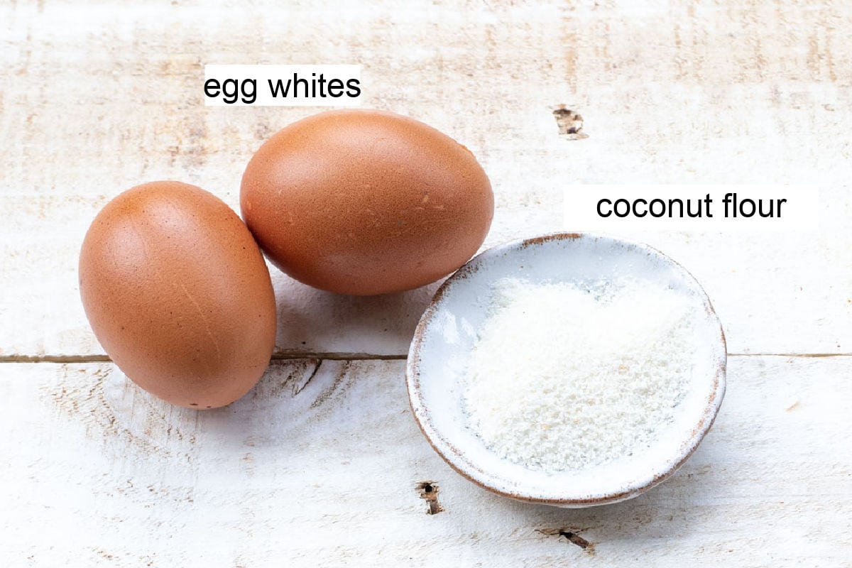 Two eggs and a bowl with coconut flour.