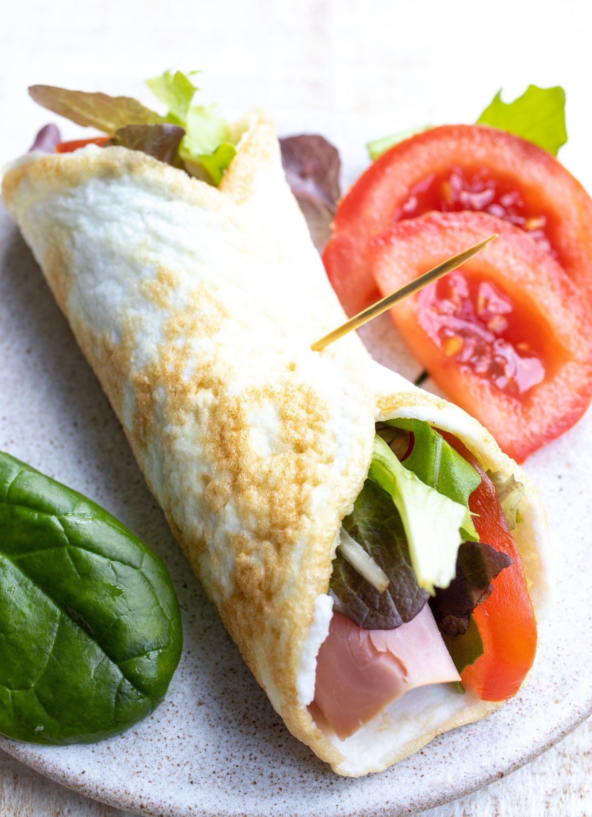A filled egg white wrap on a plate.