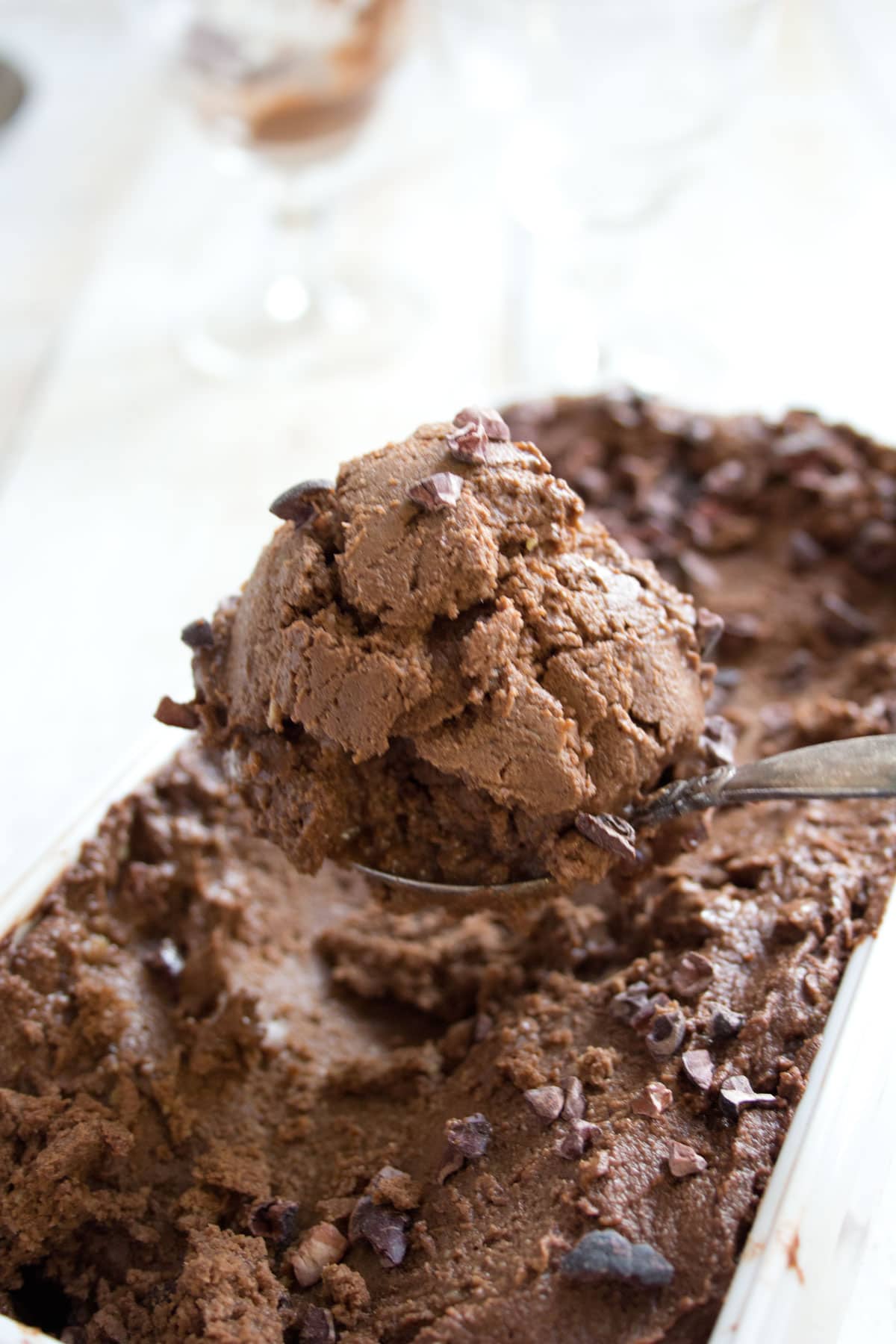 Spooning a scoop of chocolate ice cream.