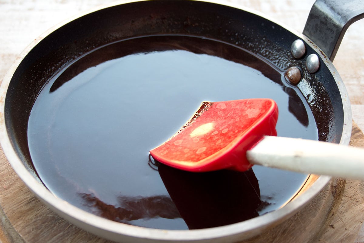 Melted chocolate in a pan and a spatula.