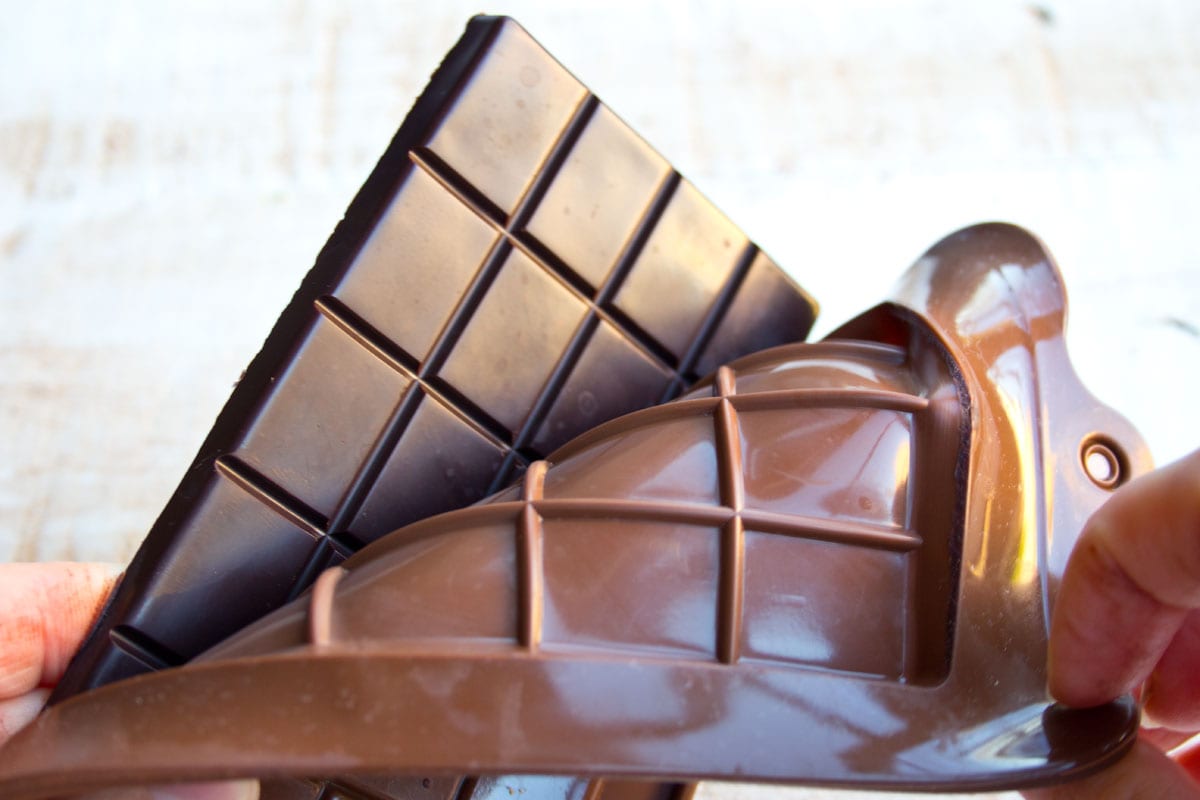 Peeling a chocolate bar out of a mold.