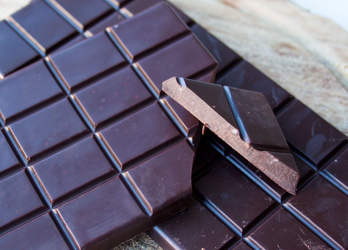 A chocolate bar and a piece broken off.