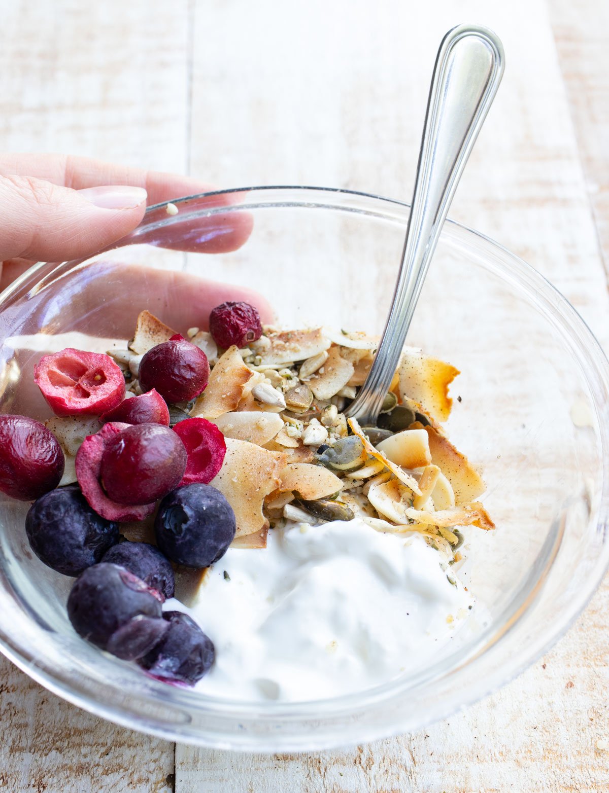 Muesli in a bowl with yogurt and berries.