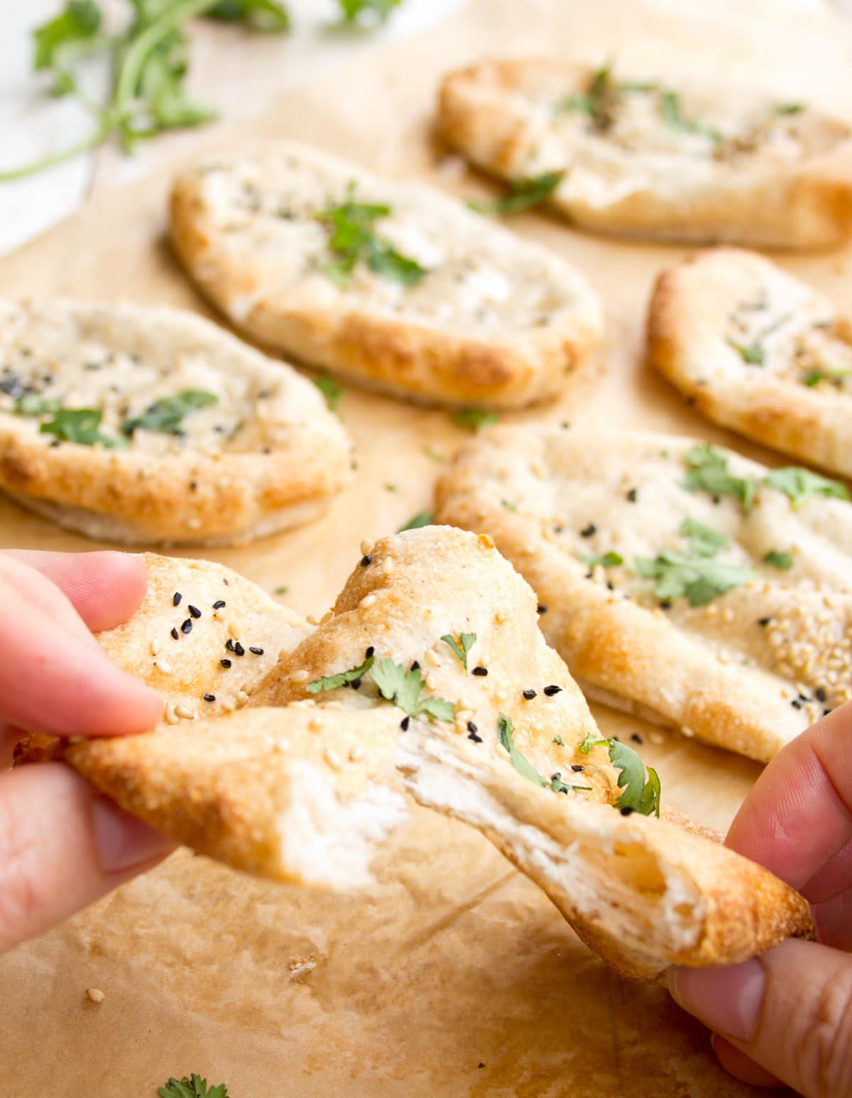 Tearing a naan bread in half.