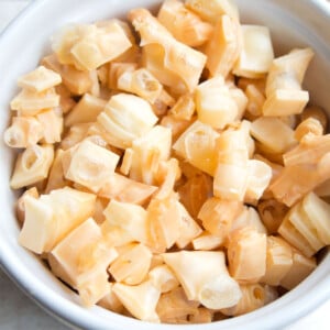 Puffed cheese squares in a white bowl.