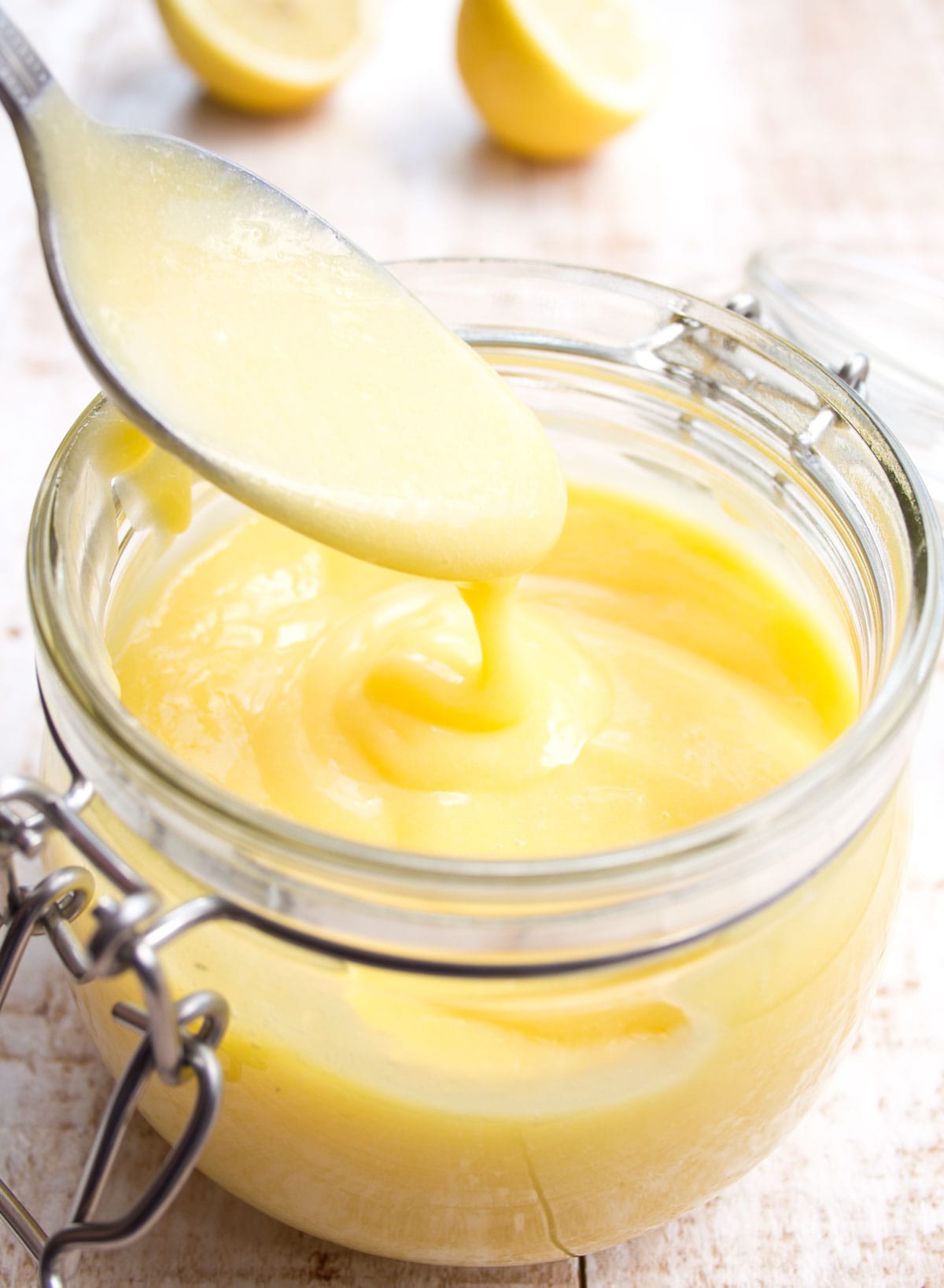 A spoon dipped into lemon curd.