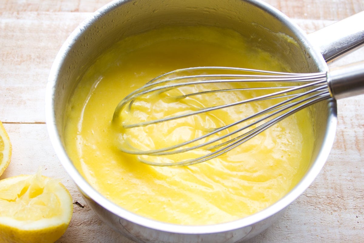 Whisking lemon curd with a ballon whisk.