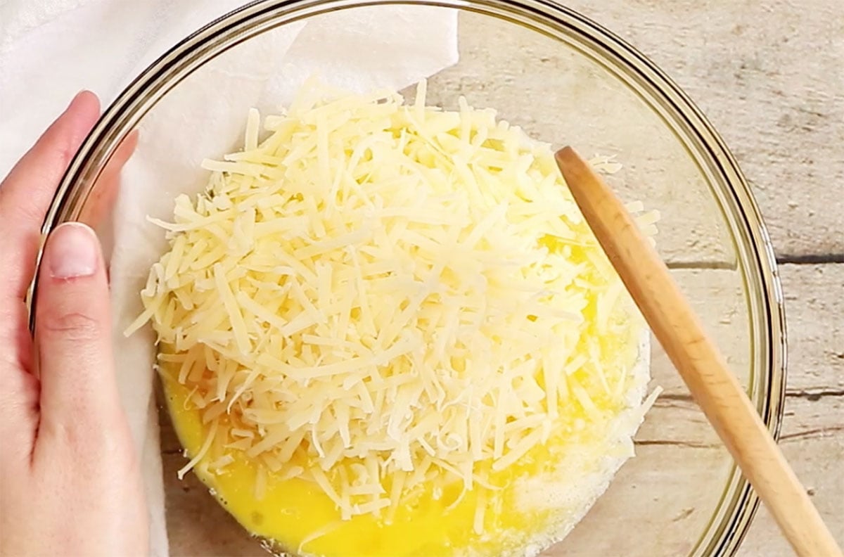 Mixing ingredients for this recipe in a glass mixing bowl with a spatula.