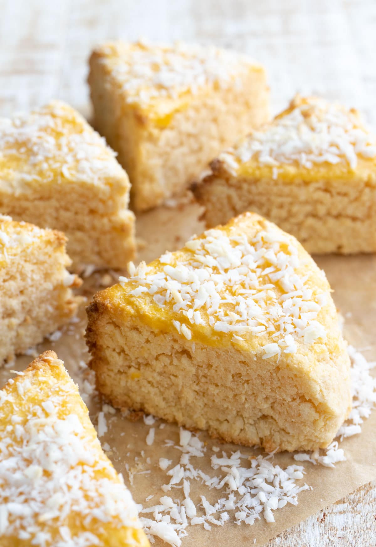 A triangular scones topped with desiccated coconut.