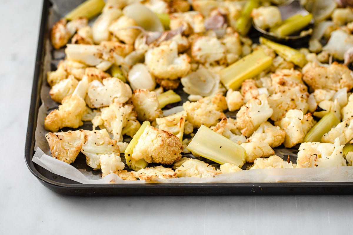 Roasted vegetables on a baking tray.