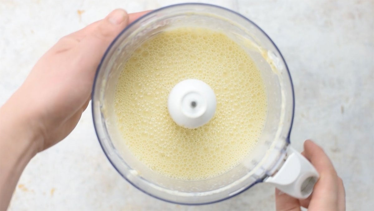 Crepe batter in a food processor bowl.