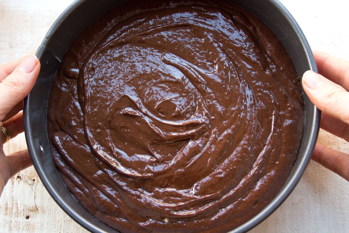 Chocolate cake batter in a springform pan.