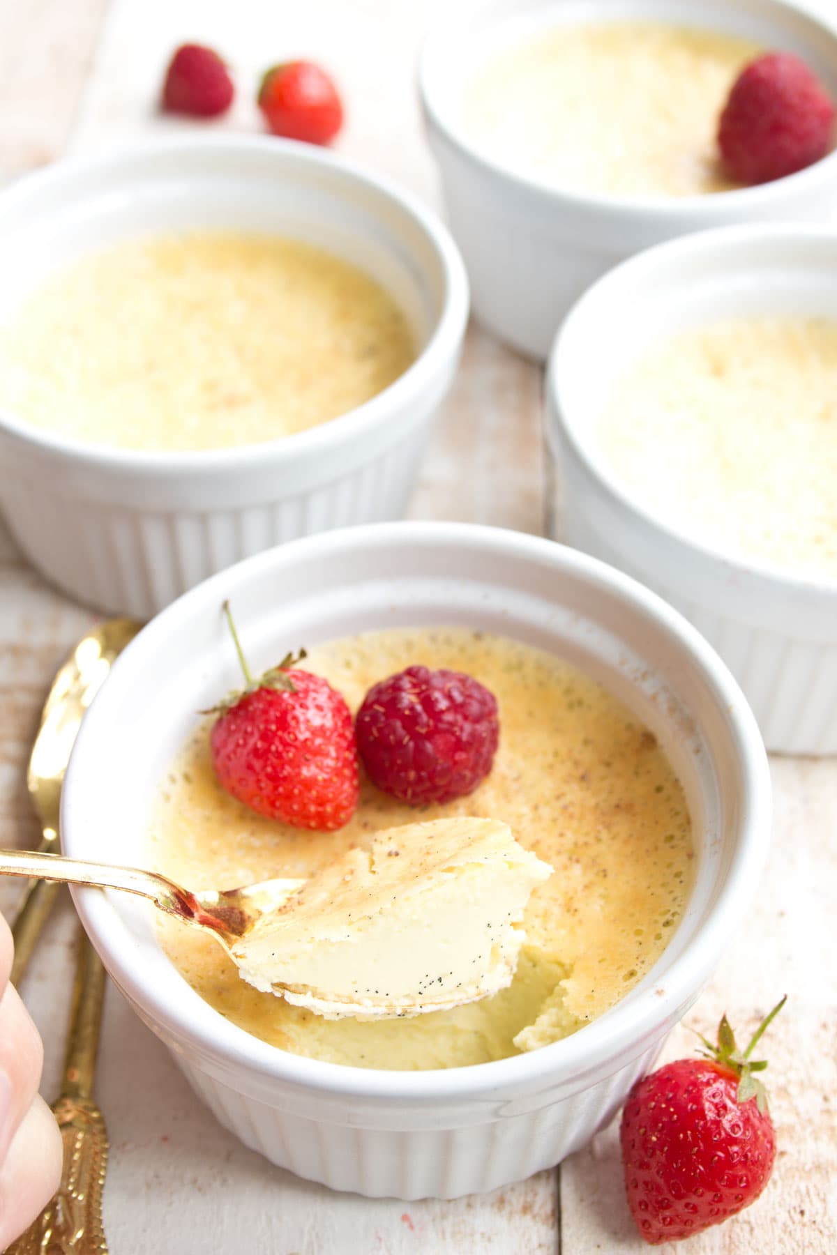 A ramekin with vanilla custard and a spoon.