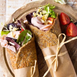 Flaxseed wraps filled with cooked ham, grated cheese, lettuce and tomatoes.
