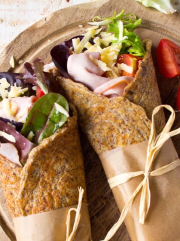 Flaxseed wraps filled with cooked ham, grated cheese, lettuce and tomatoes.