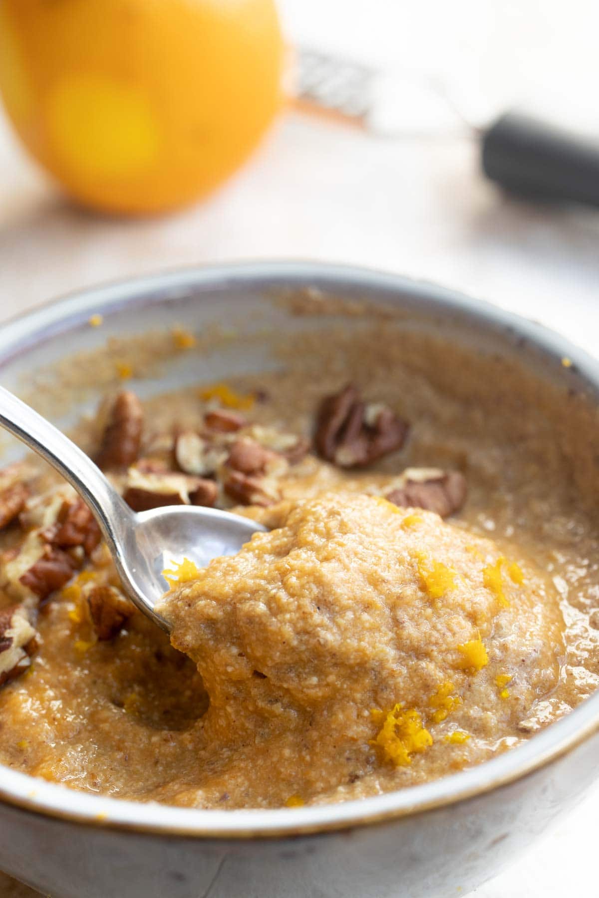 Taking a spoonful of pumpkin porridge.