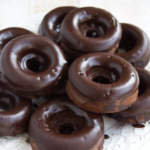 A plate with chocolate glazed keto donuts.