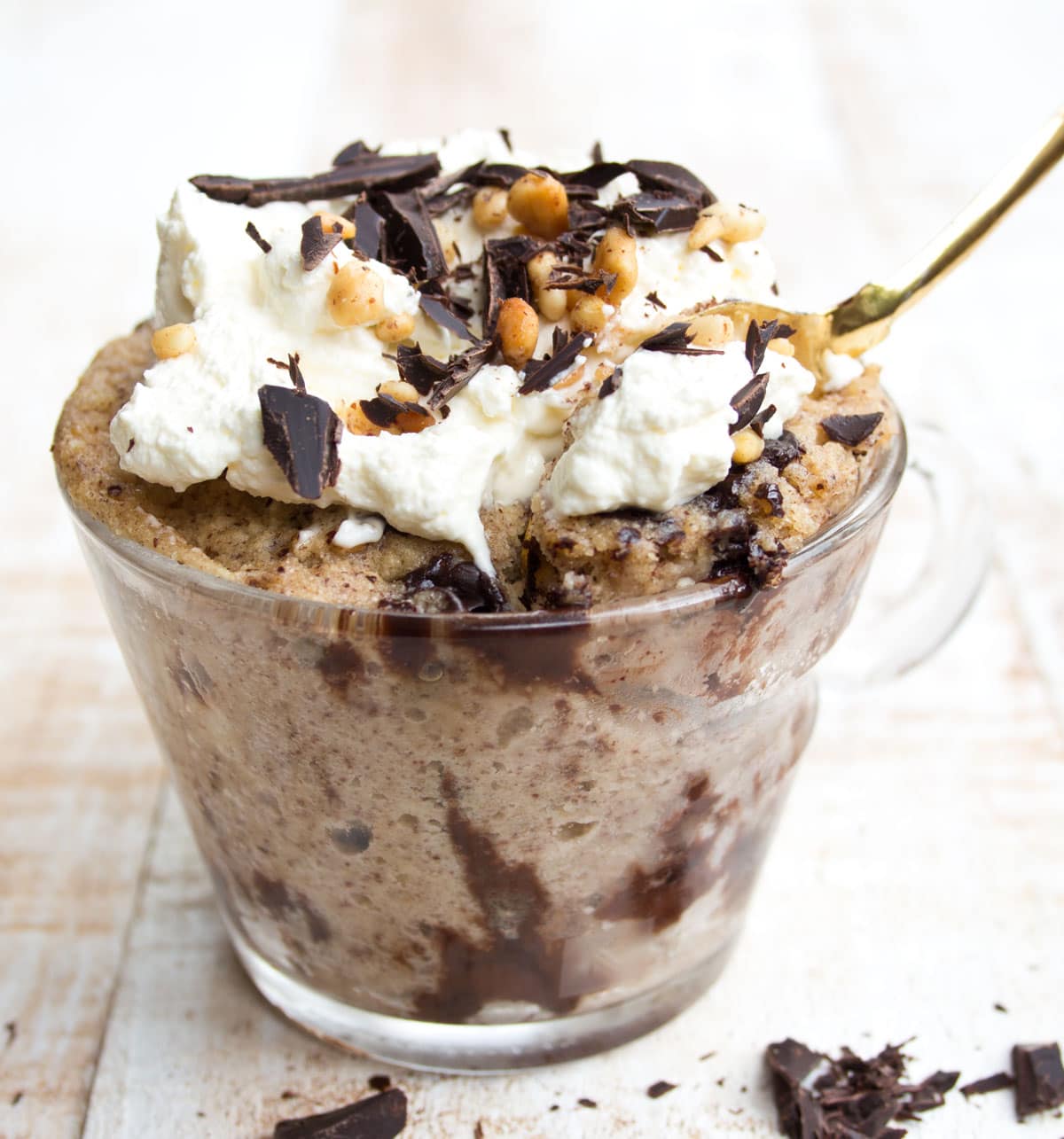 A chocolate peanut butter mug cake in a glass mug.