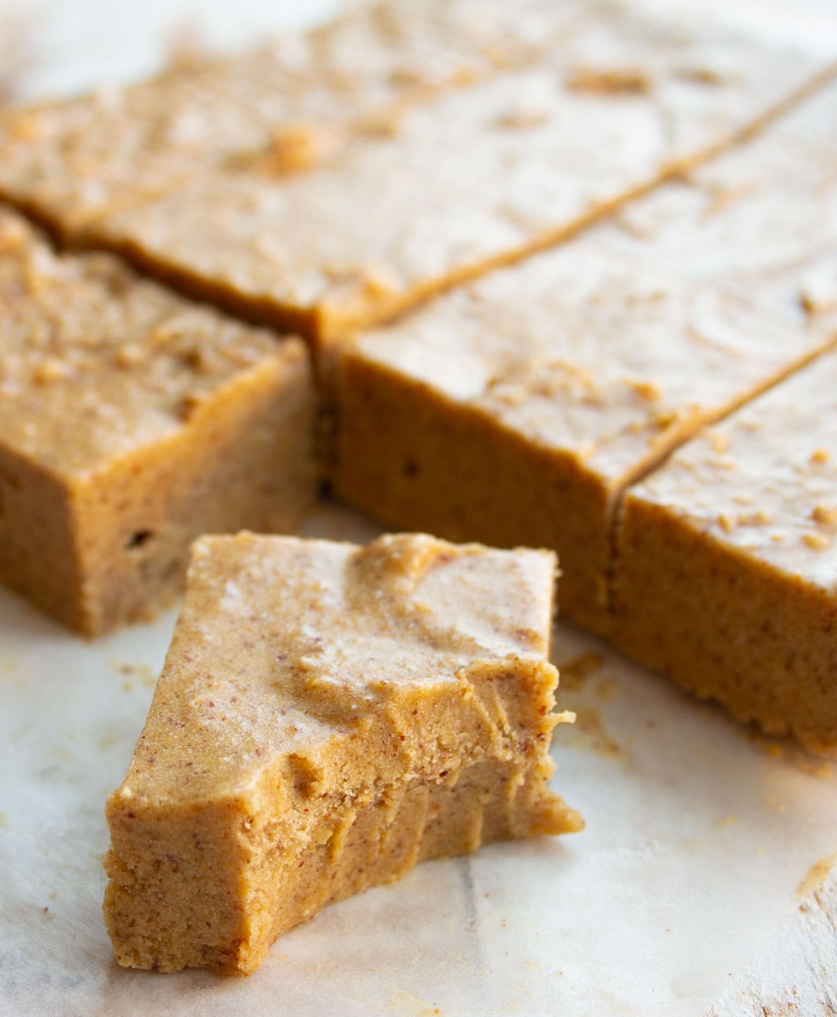 A peanut butter fudge square with teeth marks.