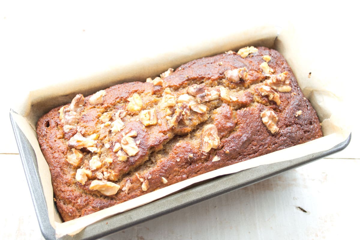 Baked banana bread in a loaf pan.