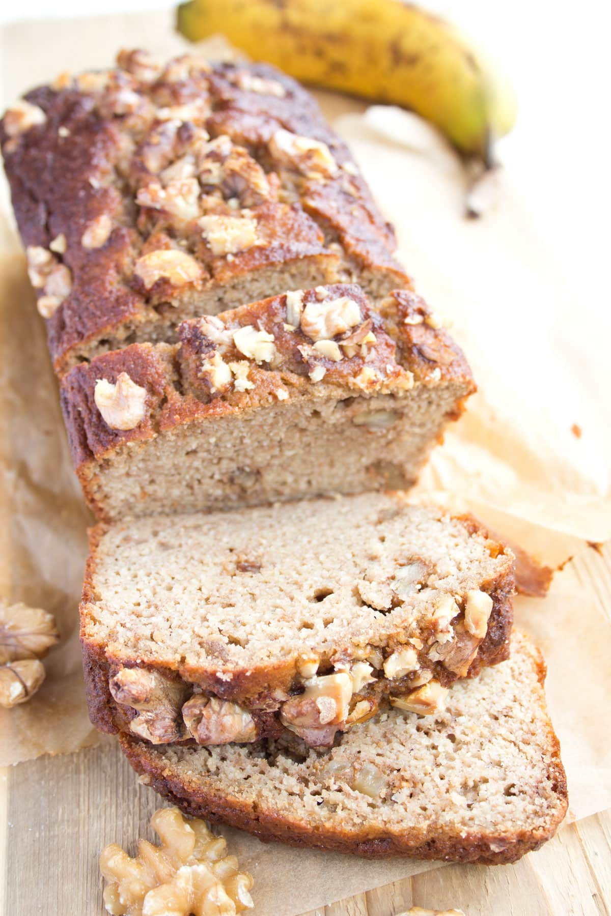 A loaf of keto banana bread topped with walnuts.