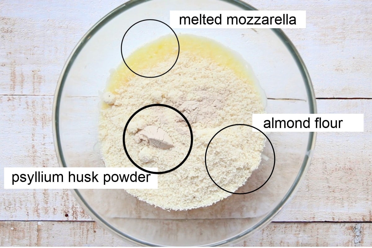 Mozzarella, almond flour and psyllium husk powder in a bowl.