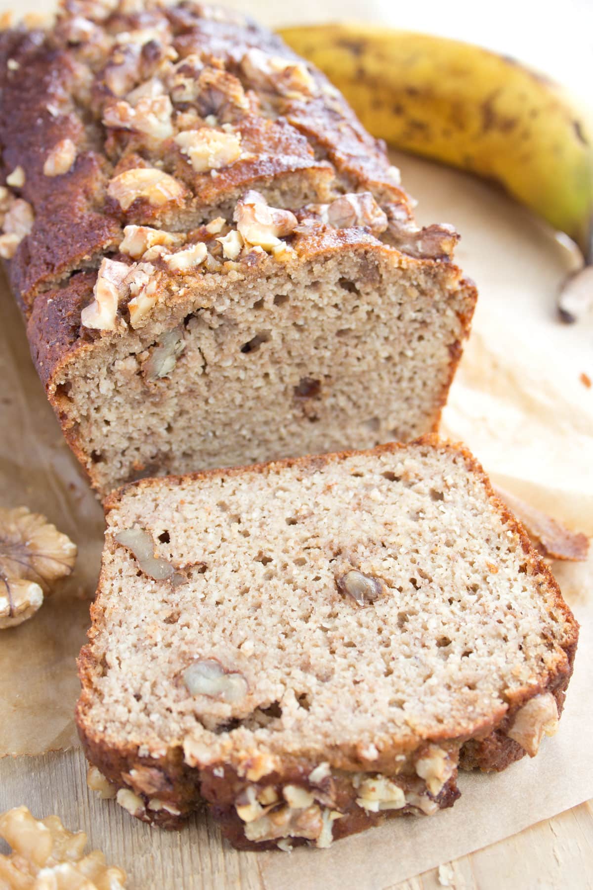 A loaf of banana bread with a slice cut off.