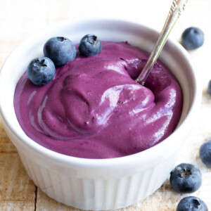 A bowl with blueberry cream cheese topped with blueberries.