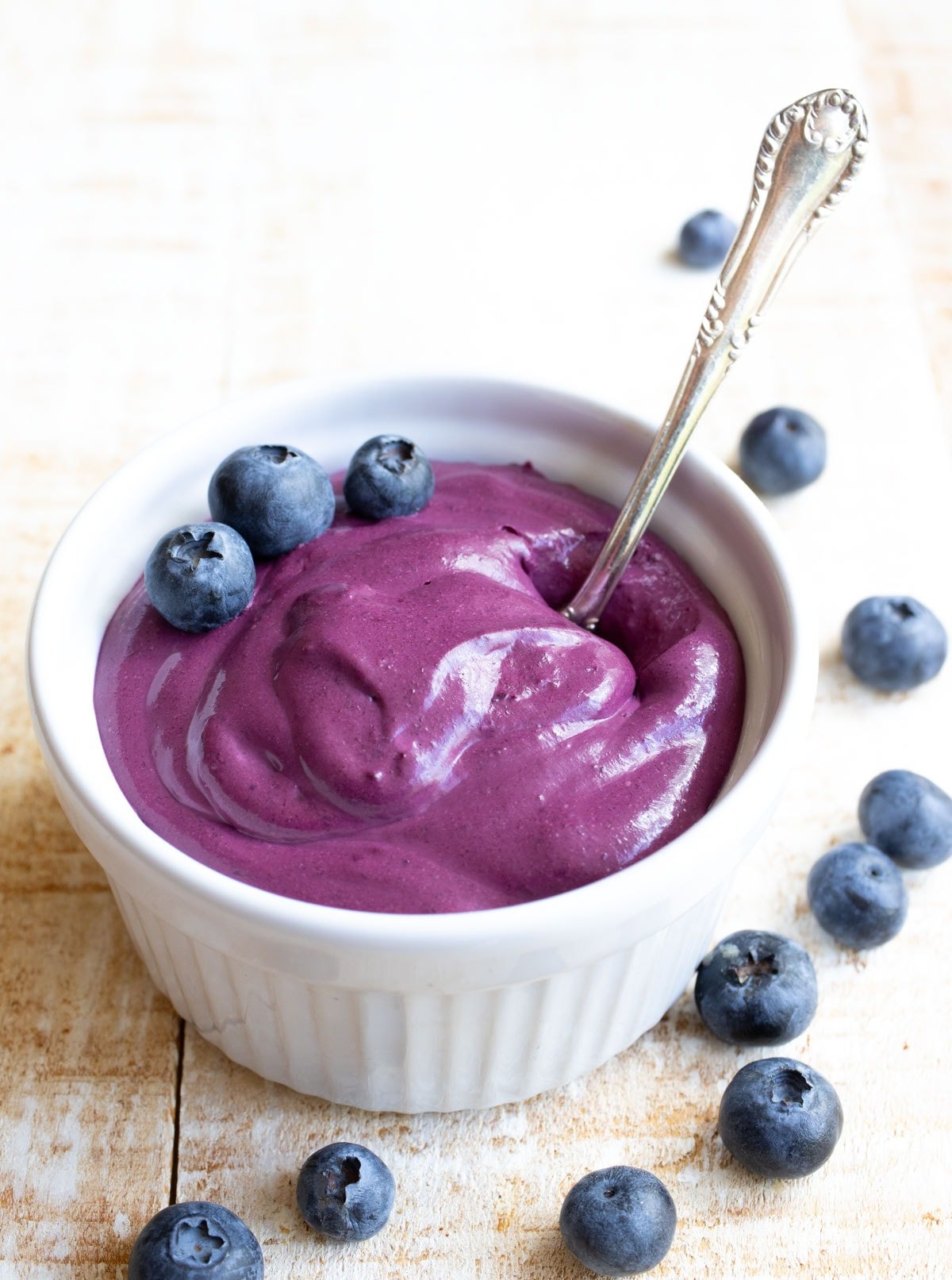 Blueberry cream cheese in a bowl with a spoon.