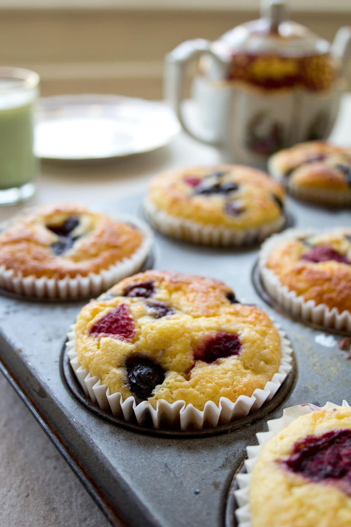 Low carb muffins with berries in a muffin pan.