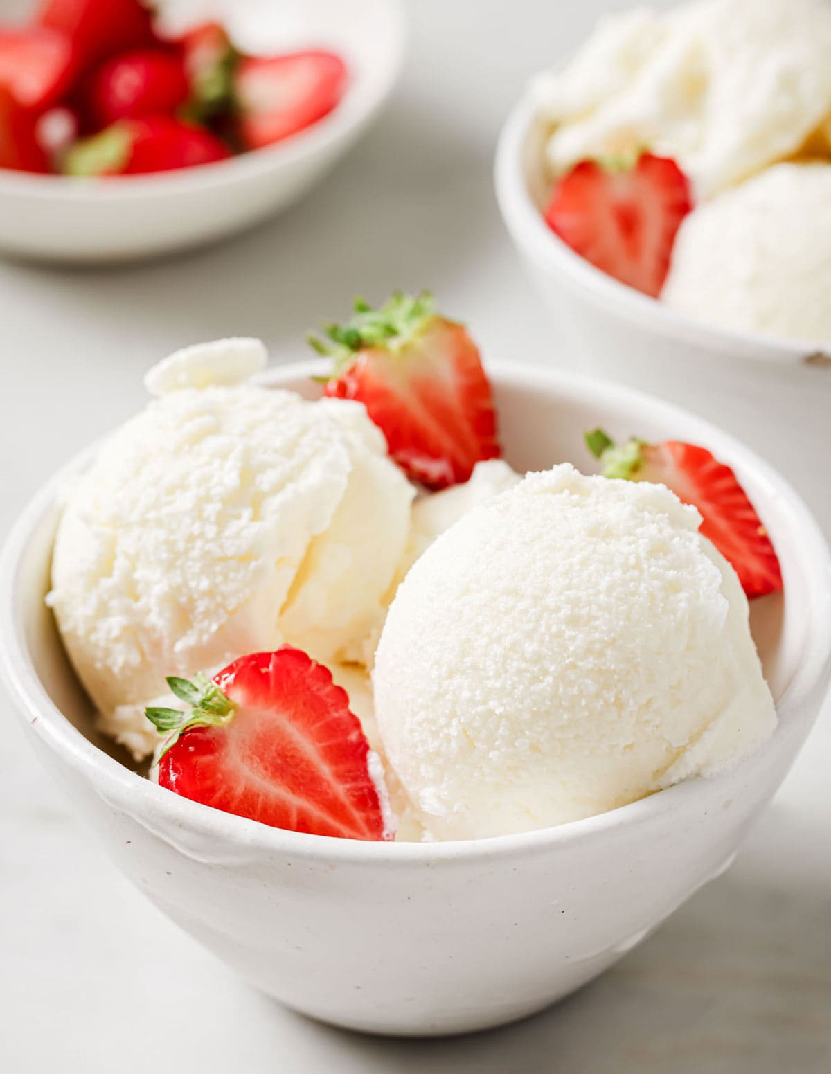 Sugar-free frozen yogurt in a bowl with strawberries.