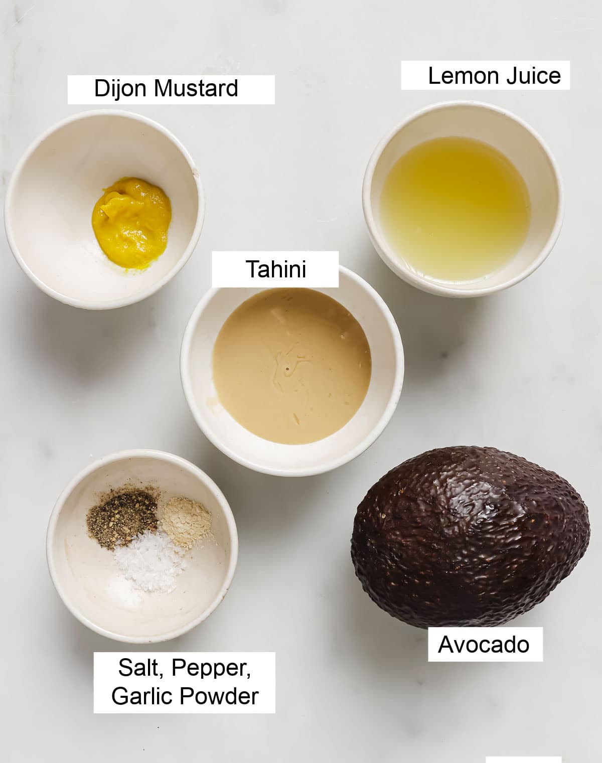 Ingredients to make avocado spread, measured into bowls and labelled.