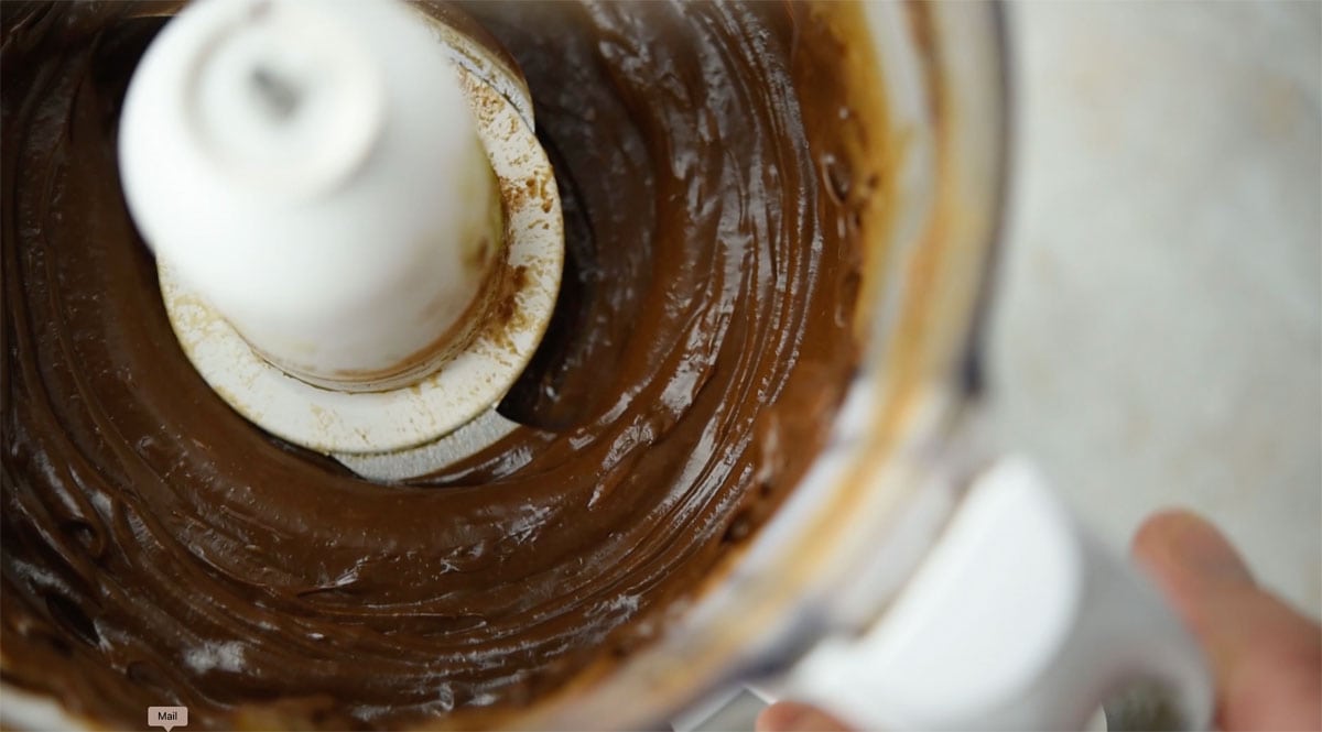 Chocolate avocado frosting in a food processor.